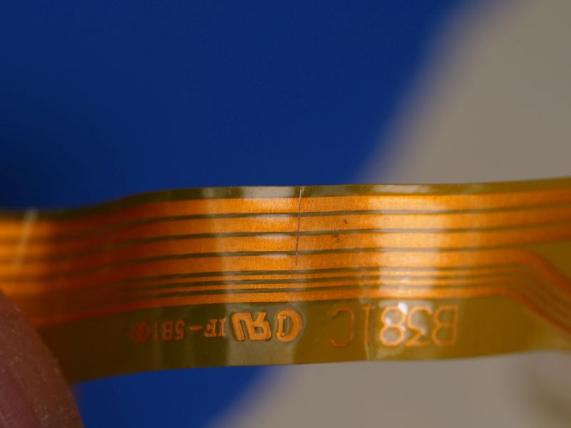 Thin 8 trace flex cable with 3 traces showing a shear line.