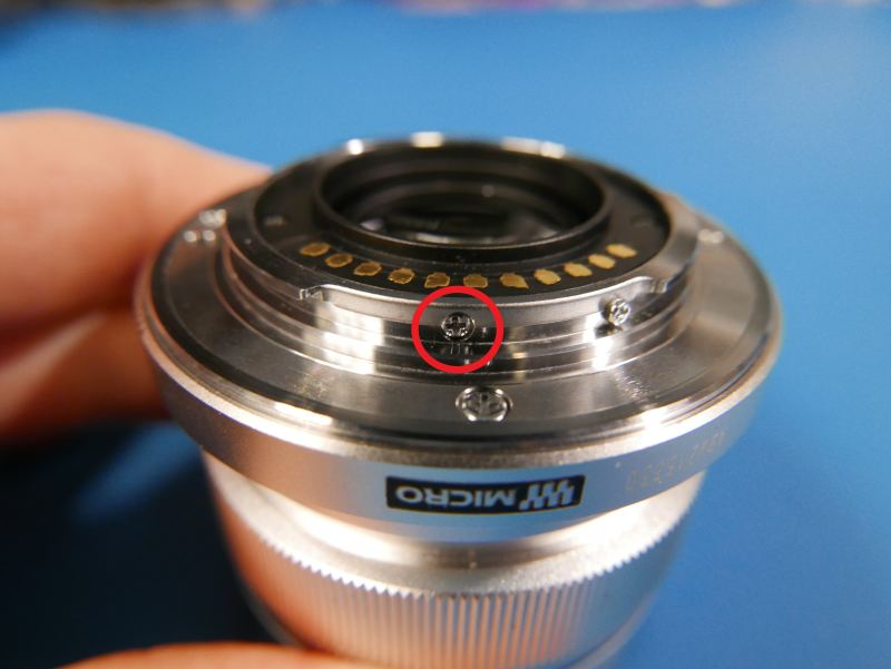 Tiny chamfered screw hidden away in the side of the lens mount.
